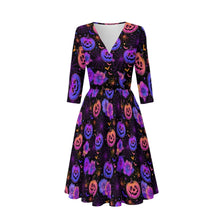 Load image into Gallery viewer, A women's fit-and-flare dress with three-quarter sleeves and a V-neckline, featuring a black background covered in a vibrant pattern of purple, pink, and orange jack-o'-lantern faces and spiderwebs.